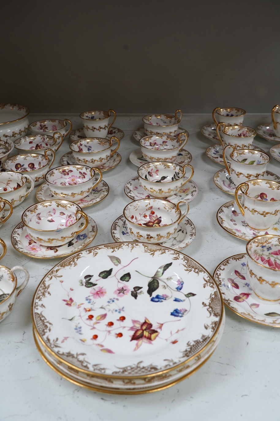 A floral part tea and coffee set, probably Swansea, c.1815-20, largest 23.5cm diameter. Condition - mostly fair